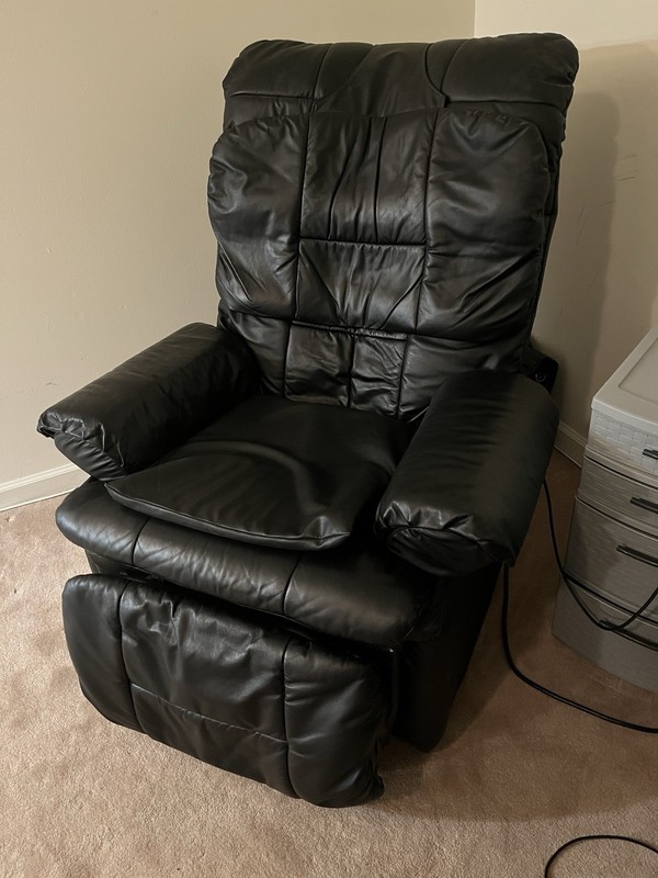 Black leather reclining massage chair with remote control attached for Options gallery